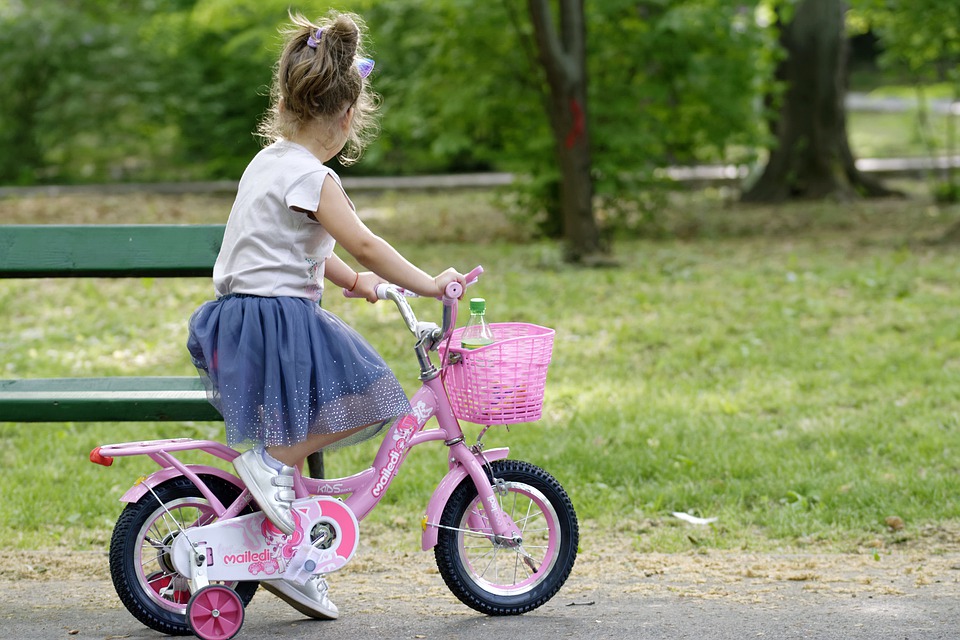 Child on bike in a park