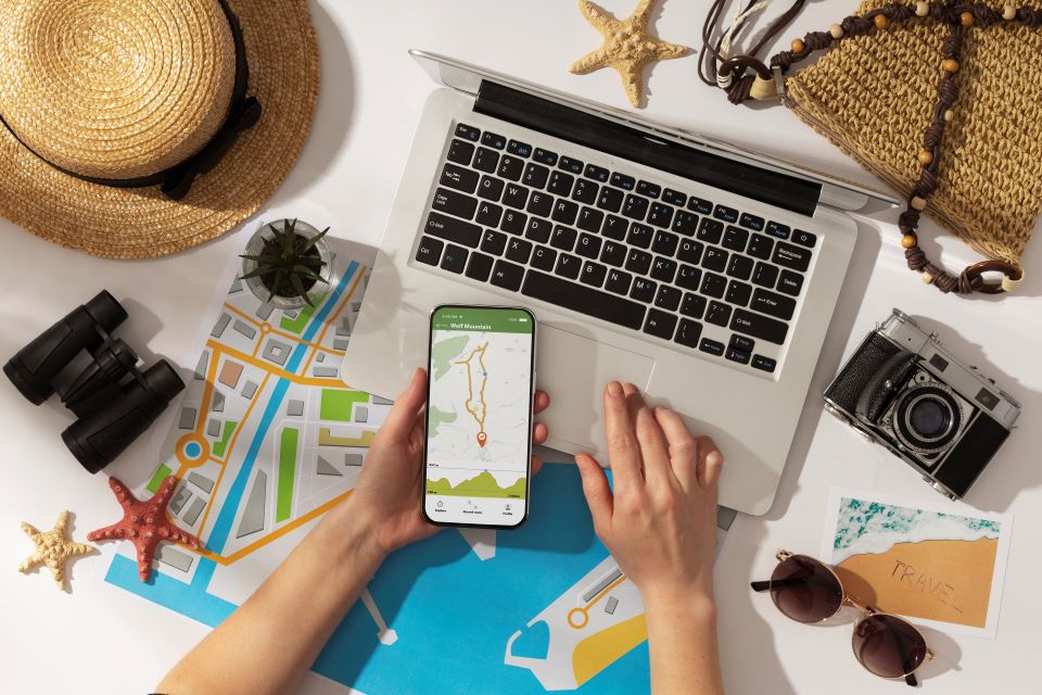 Smartphone with map and travel essentials on a desk.